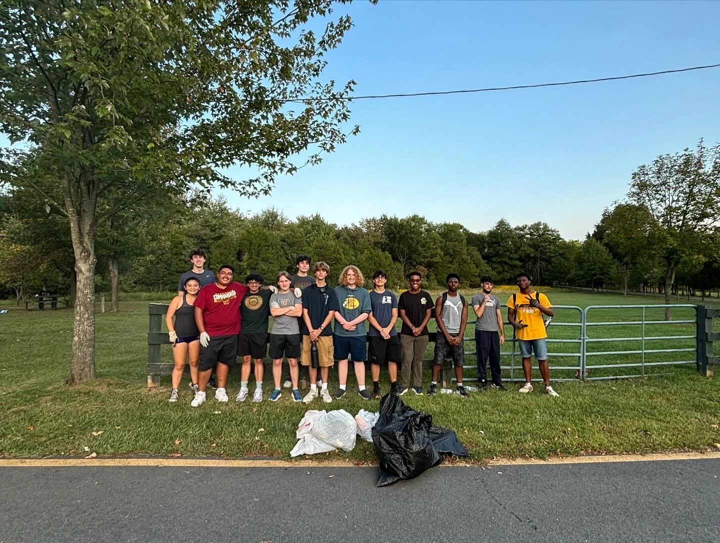 A large group of LNCP student volunteers gathered after a park cleanup